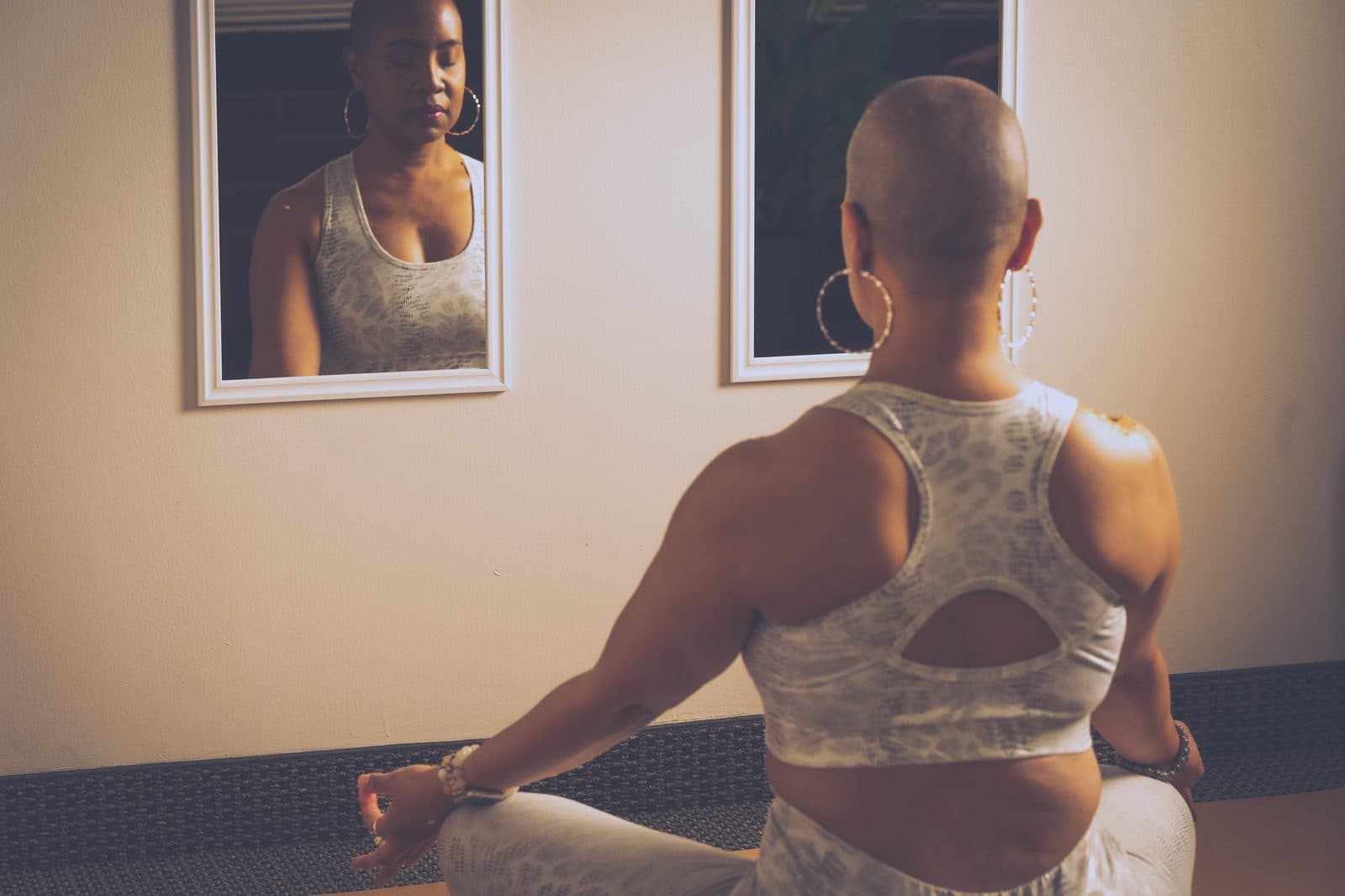 Dr. Crystal in reflective meditation facing a mirror